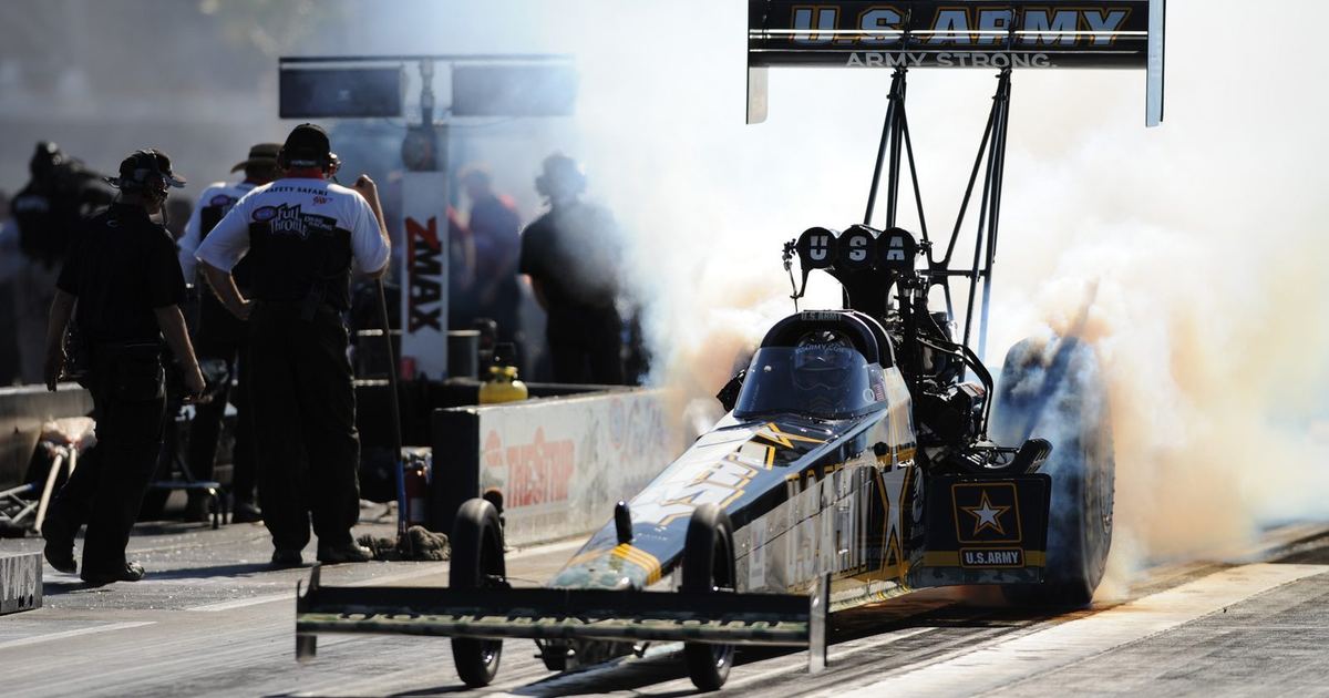 a dragster performing a burnout before staging for a run