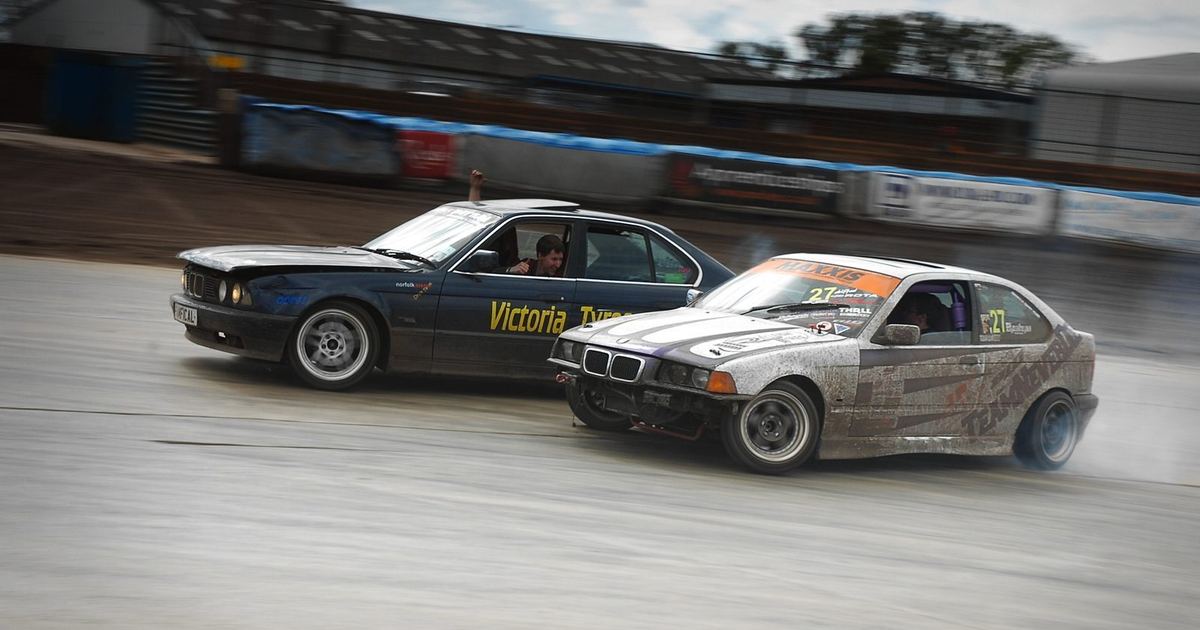 Two cars running a tandem drift battle
