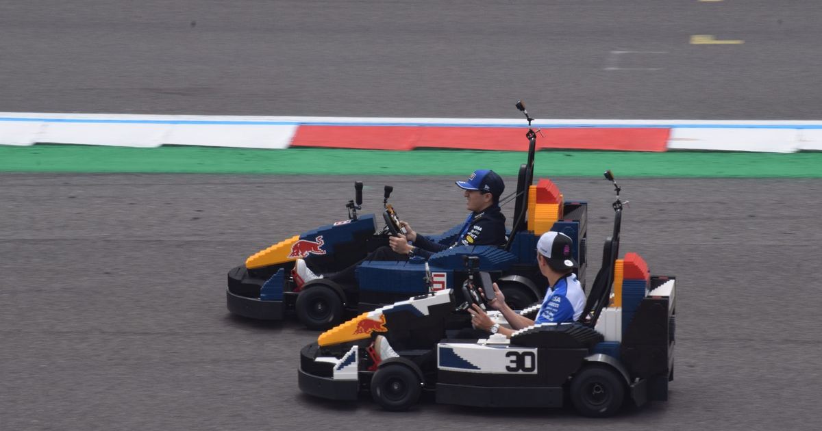 Isack Hadjar and Liam Lawson together at a promotional event during the 2026 British Grand Prix weekend