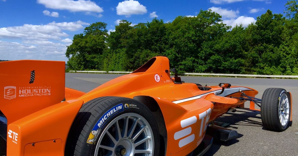a Formula E car cornering, ideally showing it taking a wide or unusual line consistent with an Attack Mode activation zone
