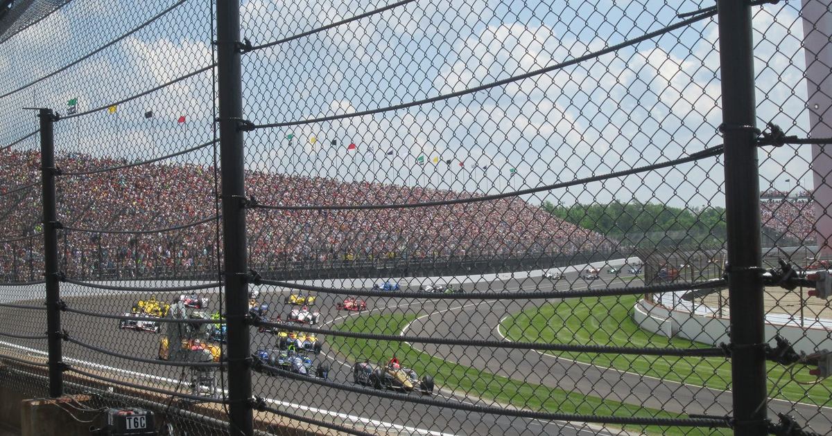 a historic photograph of Indianapolis Motor Speedway or an early IndyCar, illustrating the championship's long oval-racing heritage