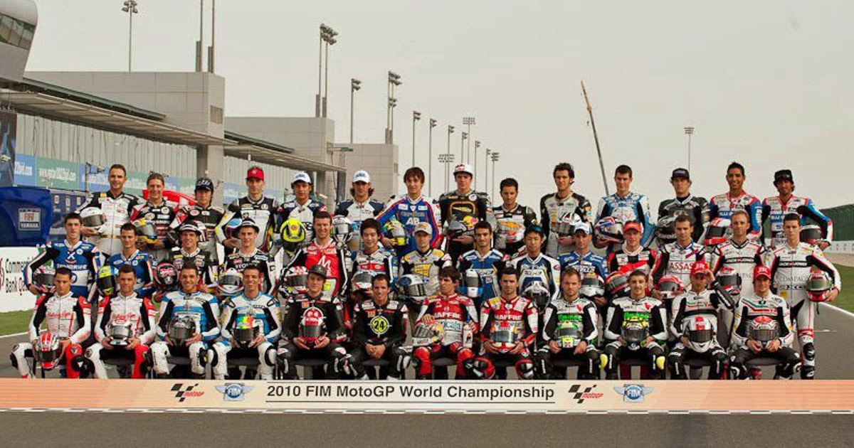 A pack of Moto2 riders racing closely together on the grid