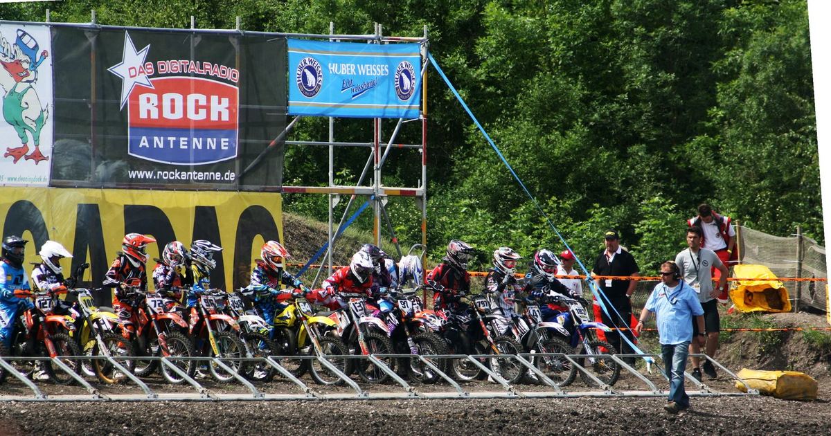 an outdoor motocross rider on natural terrain, representing either championship generically