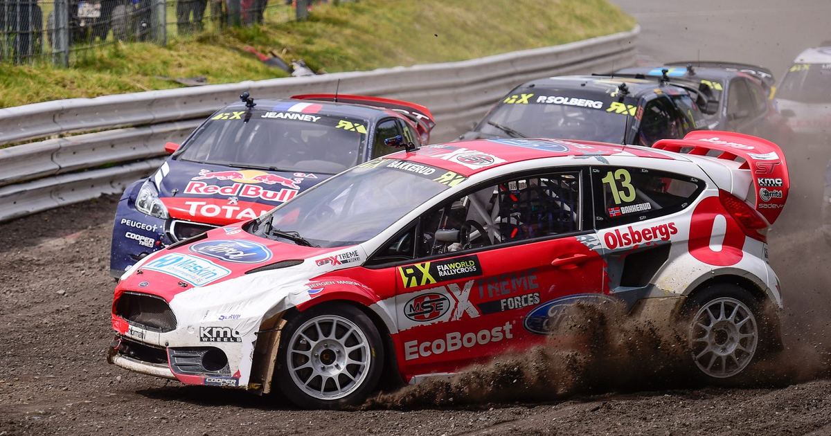 a rallycross car on a mixed tarmac-and-gravel circuit, illustrating the discipline's rally-derived origins