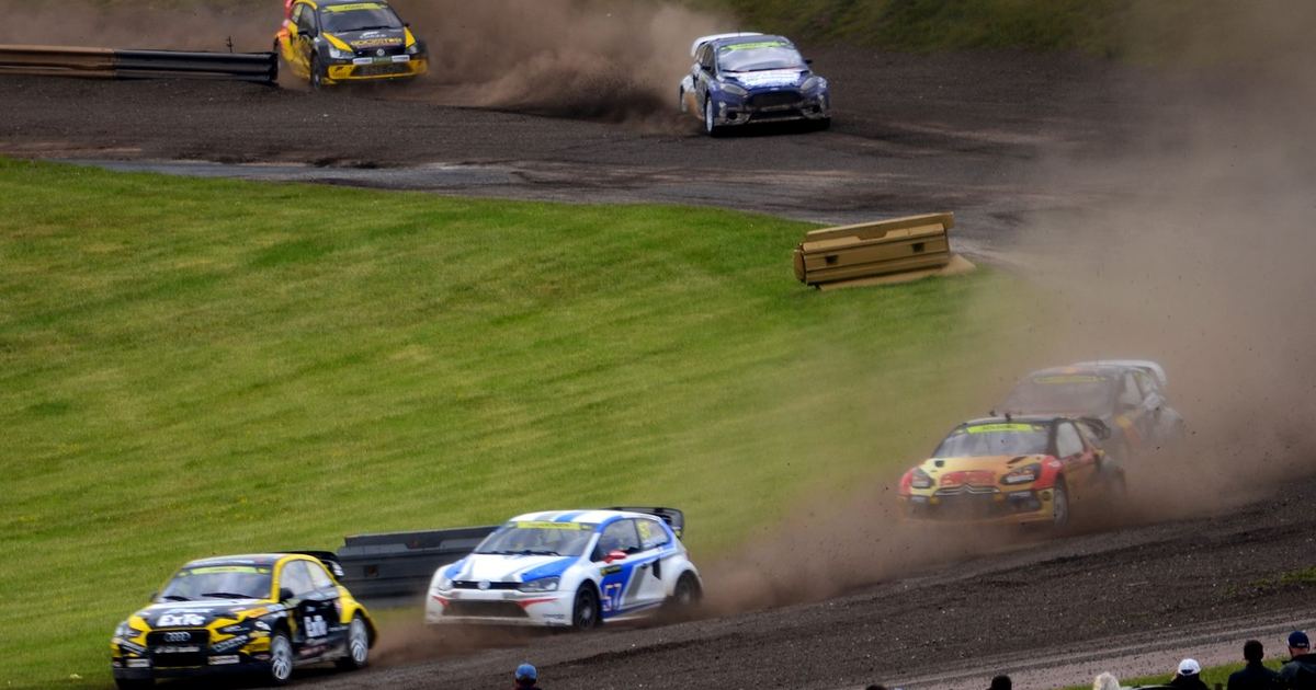 a rallycross car jumping on a mixed-surface circuit, contrasted conceptually against a WRC car on a rally stage