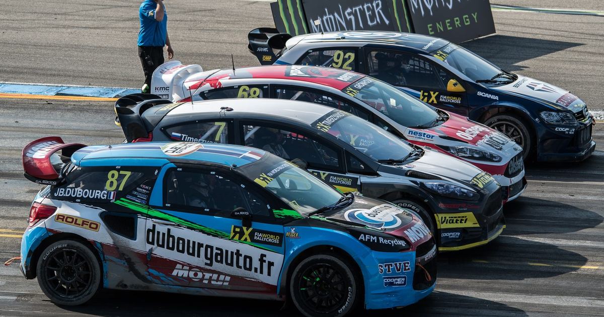 a full rallycross starting grid with several cars launching side by side