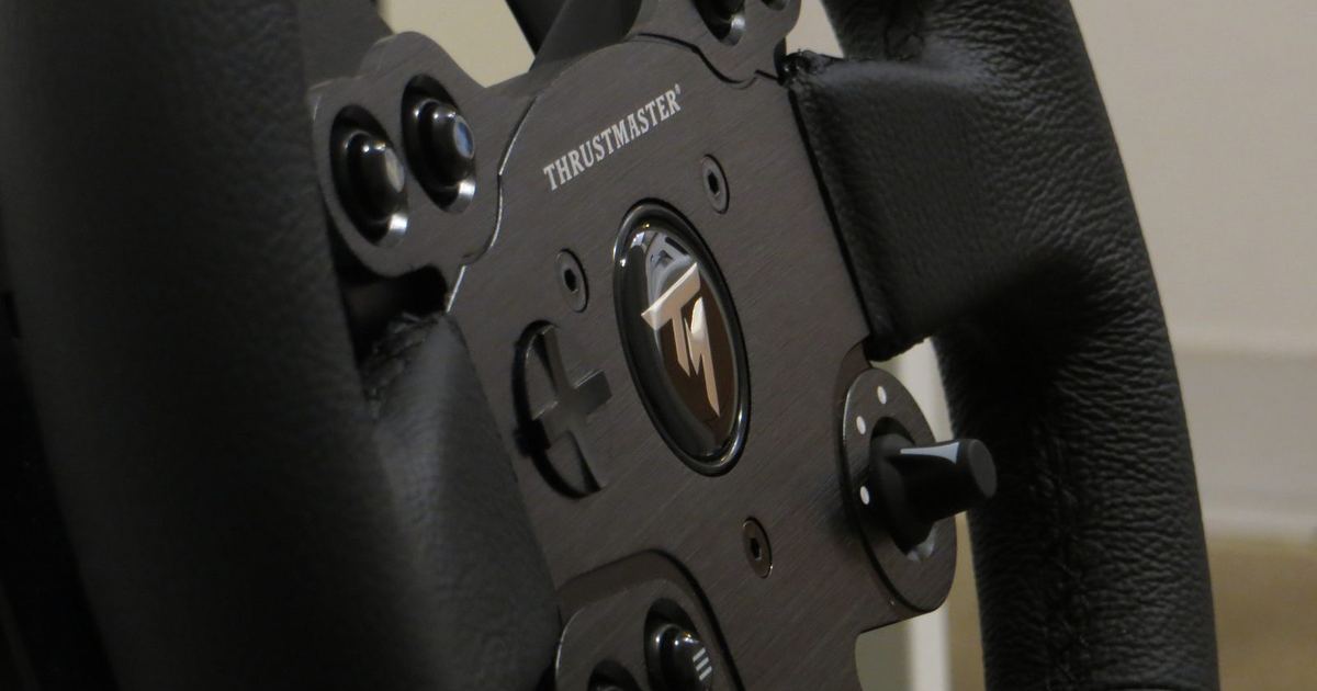 a close-up of a direct-drive wheel or load-cell pedal hardware