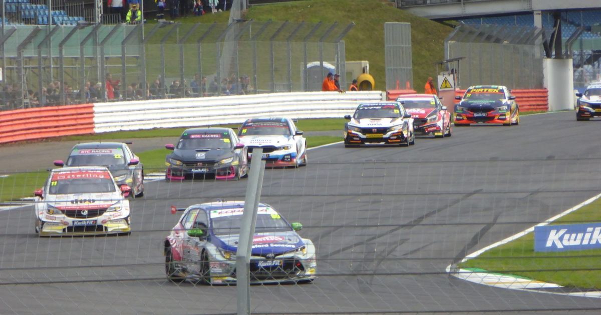 BTCC cars racing closely together, illustrating the tight midfield the equalizing system is designed to produce