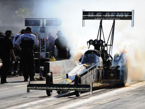 two dragsters staged side by side on the starting line before an elimination round