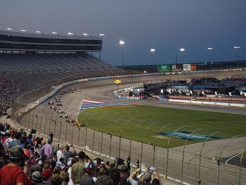 an IndyCar accelerating hard out of a corner on a road course, the moment push-to-pass would typically be deployed