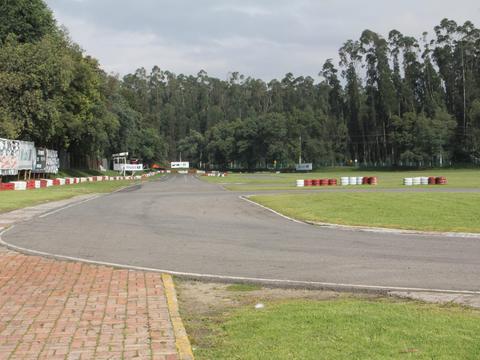 a field of competition karts racing at a national or international level event