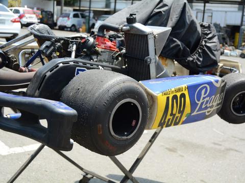 a young driver in a competitive kart, positioned to suggest a comparison with sim racing training