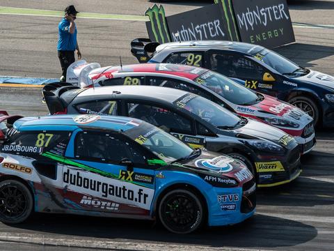 a full rallycross starting grid with several cars launching side by side