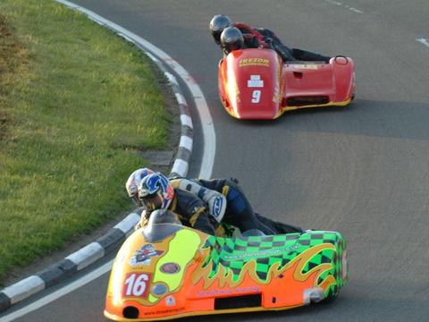 a road-racing sidecar outfit on a circuit, illustrating the discipline's history and distinct format