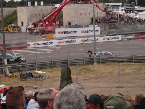 touring cars racing door to door on a road course, contrasted conceptually against oval racing