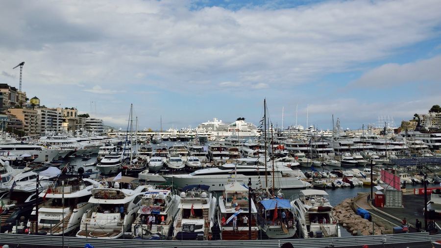 Monaco's famous harbour, packed with yachts, alongside the circuit during a Formula 1 Monaco Grand Prix race weekend.