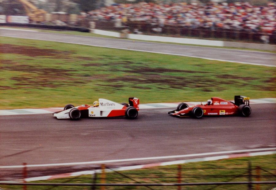 Ayrton Senna's McLaren and Alain Prost's Ferrari racing side by side at the 1991 Mexican Grand Prix.