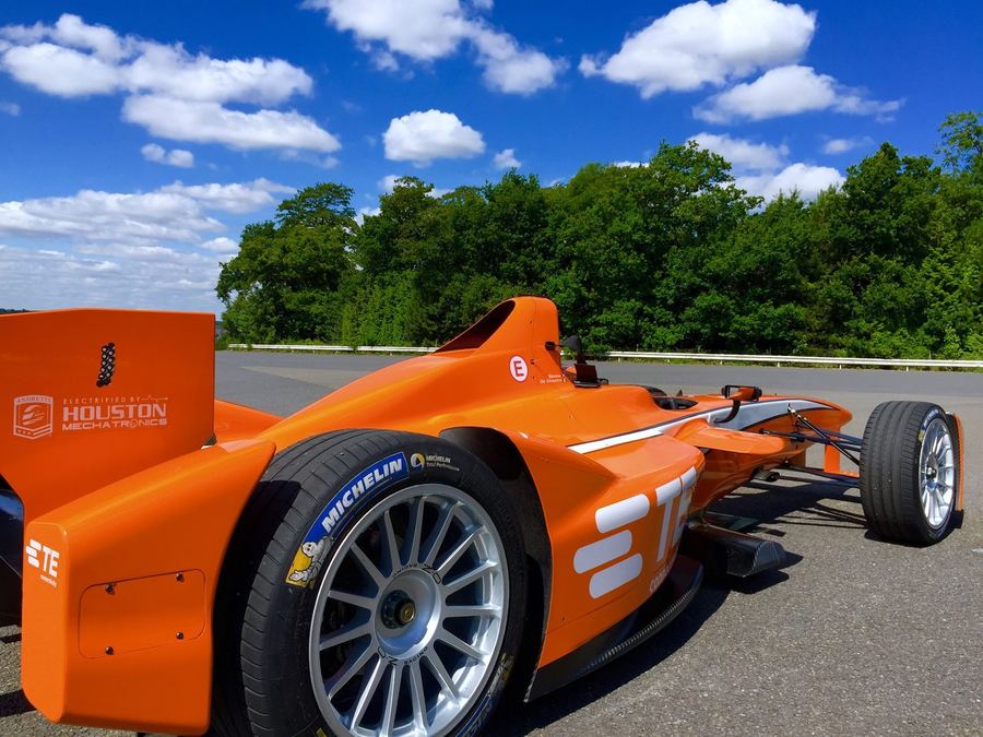 a Formula E car cornering, ideally showing it taking a wide or unusual line consistent with an Attack Mode activation zone