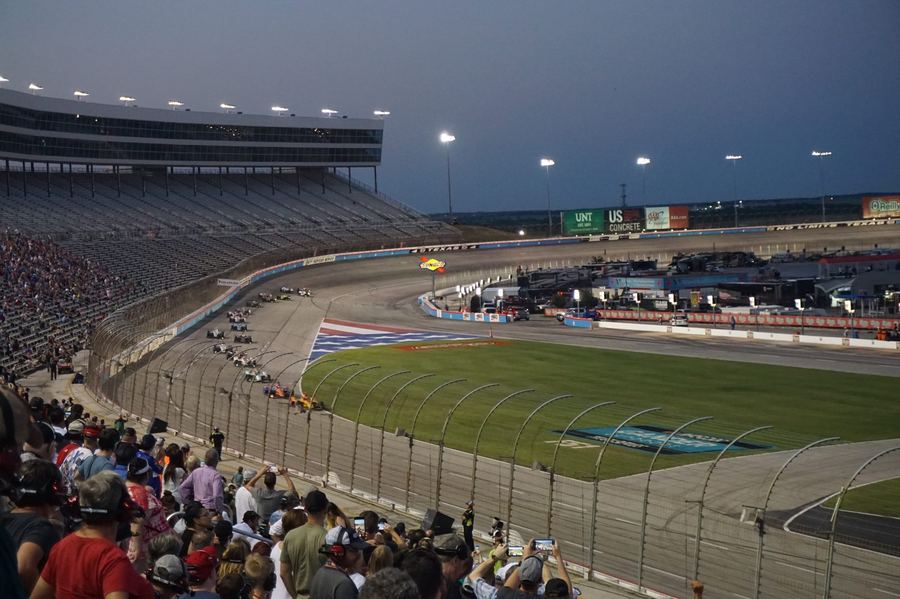 an IndyCar accelerating hard out of a corner on a road course, the moment push-to-pass would typically be deployed