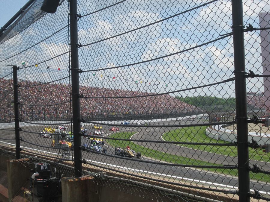 a historic photograph of Indianapolis Motor Speedway or an early IndyCar, illustrating the championship's long oval-racing heritage