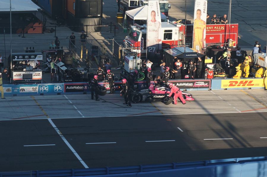 Kyle Kirkwood's Andretti Global car (#27) during a pit stop, with a banner bearing his name visible in the background