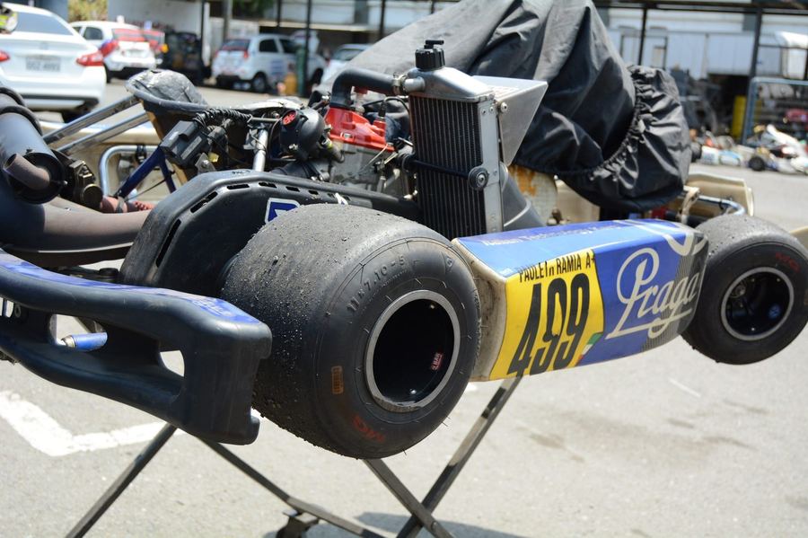 a young driver in a competitive kart, positioned to suggest a comparison with sim racing training