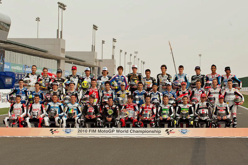 A pack of Moto2 riders racing closely together on the grid