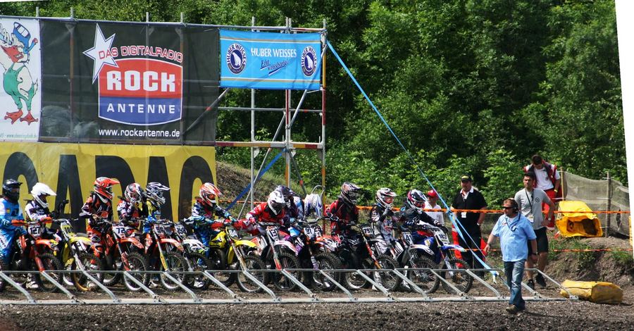 an outdoor motocross rider on natural terrain, representing either championship generically