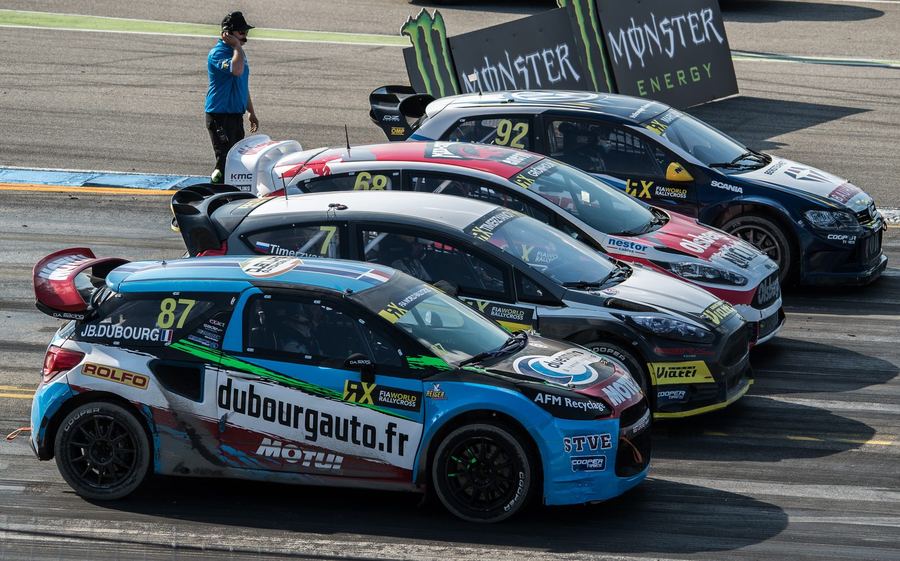 a full rallycross starting grid with several cars launching side by side