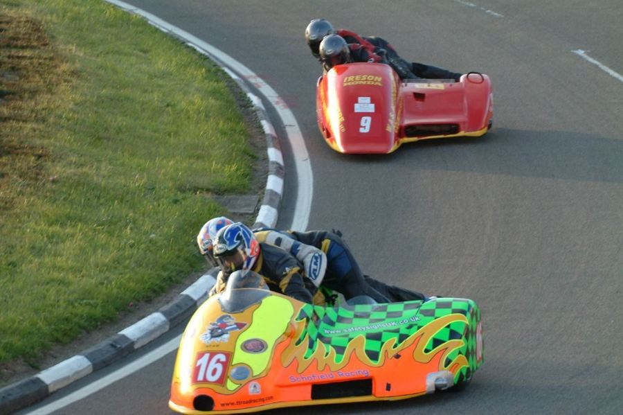 a road-racing sidecar outfit on a circuit, illustrating the discipline's history and distinct format