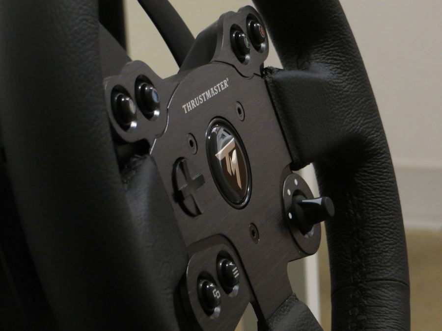 a close-up of a direct-drive wheel or load-cell pedal hardware