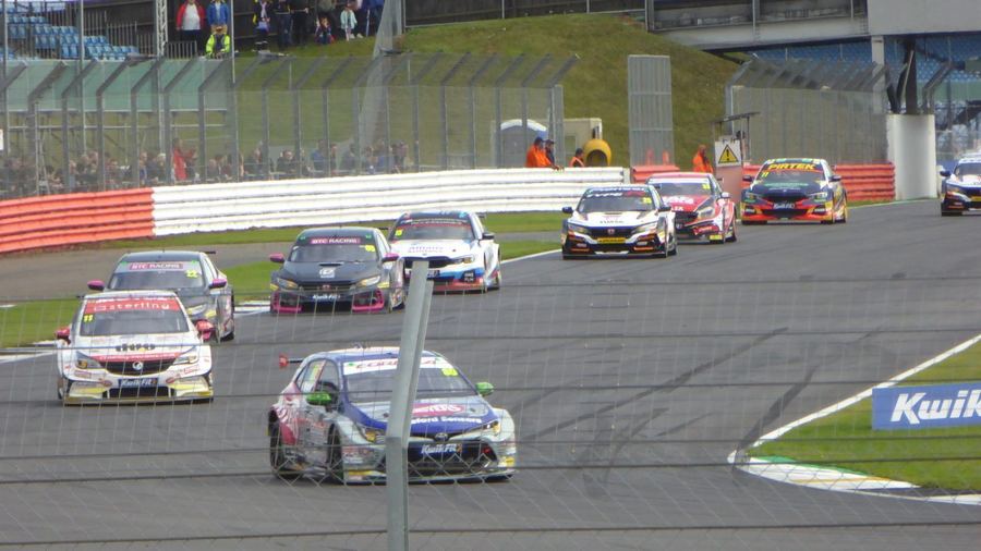 BTCC cars racing closely together, illustrating the tight midfield the equalizing system is designed to produce