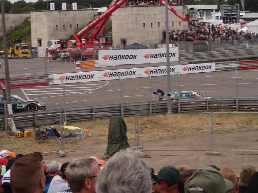 touring cars racing door to door on a road course, contrasted conceptually against oval racing